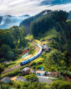 A train stopping in a mountainous countryside
