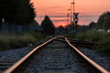 A close-up image of train tracks at night” loading=